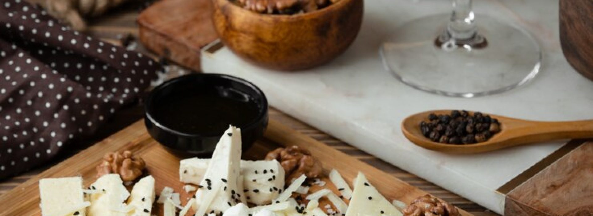 cheese-plate-on-wooden-board-with-white-wine_140725-329